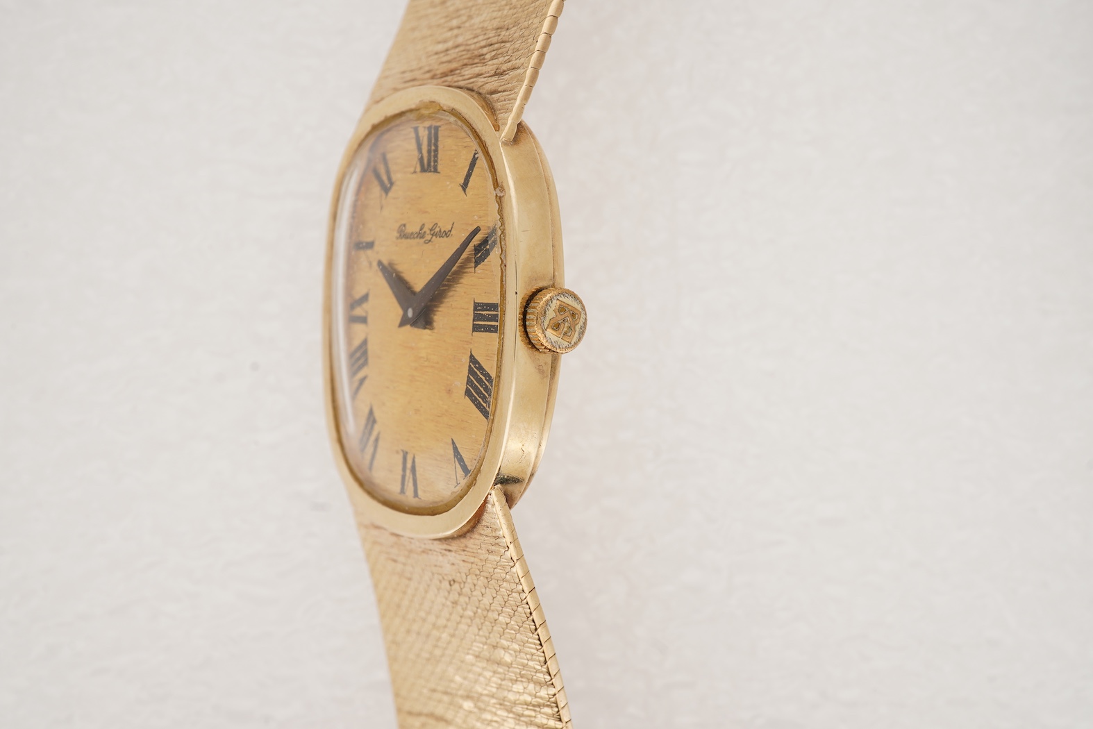A gentleman's early 1970's 9ct gold Bueche Girod manual wind dress wrist watch, on an integral 9ct gold bark effect bracelet
